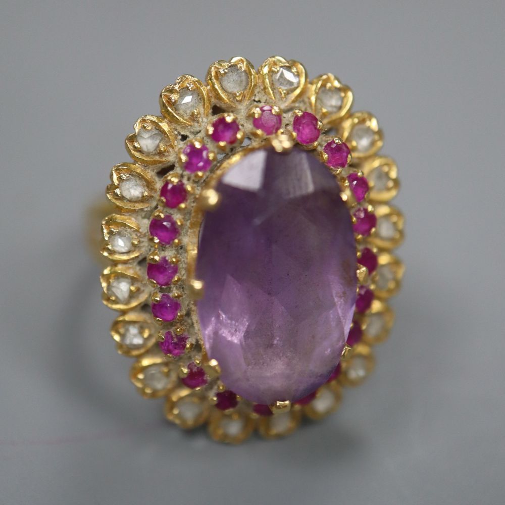 A yellow metal, amethyst, ruby and rose cut diamond set oval dress ring, with diamond set shoulders, size M